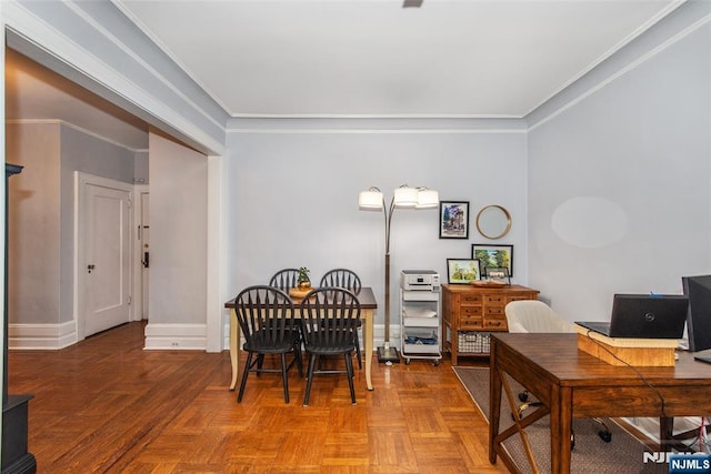 dining room with an office area, ornamental molding, and baseboards