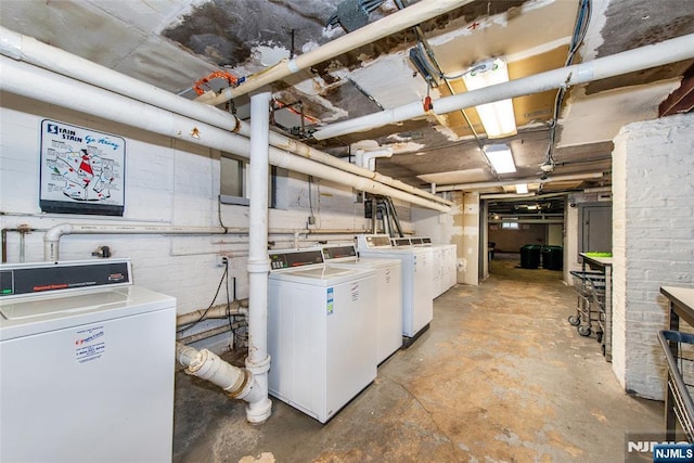unfinished basement featuring washing machine and clothes dryer