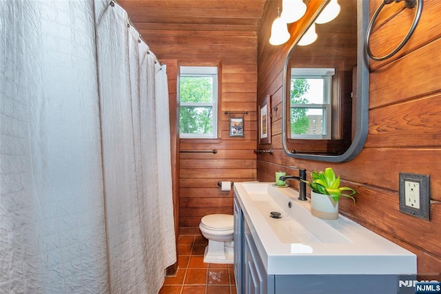 full bath with wooden walls, vanity, tile patterned flooring, toilet, and wood ceiling