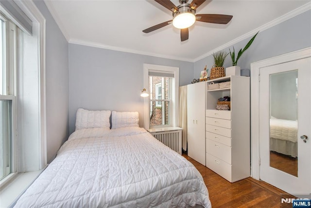 bedroom featuring radiator, ornamental molding, wood finished floors, and a ceiling fan