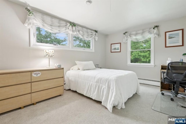 bedroom with baseboard heating and light colored carpet