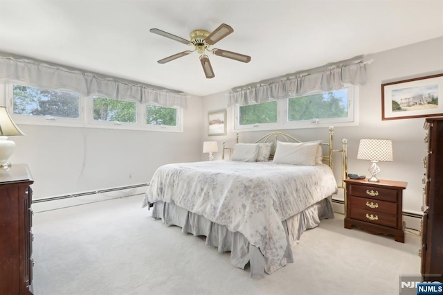 carpeted bedroom with baseboard heating, a baseboard radiator, and a ceiling fan