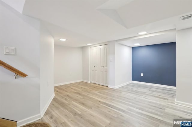 finished below grade area featuring baseboards, light wood-type flooring, and recessed lighting