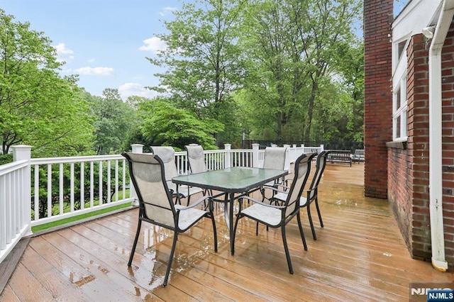 deck with outdoor dining area