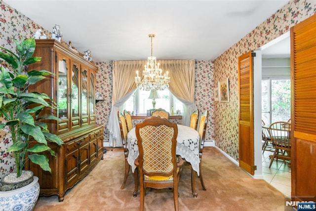 dining space featuring wallpapered walls, a chandelier, healthy amount of natural light, light colored carpet, and baseboards