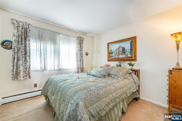 bedroom with a baseboard radiator, carpet, and baseboards