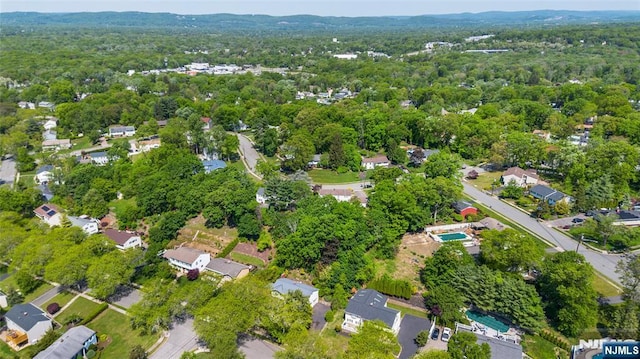 aerial view of property's location featuring a heavily wooded area
