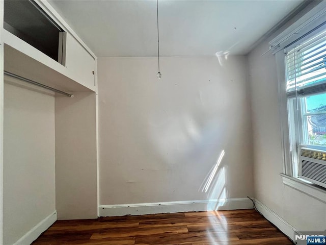 unfurnished dining area with wood finished floors and baseboards