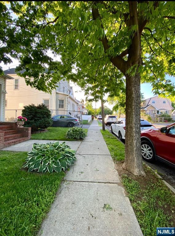 view of asphalt road featuring sidewalks and a residential view