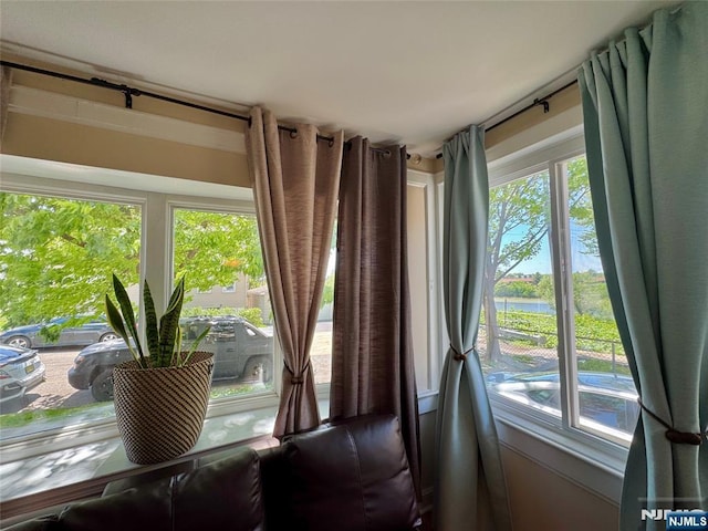 dining room with a water view and healthy amount of natural light
