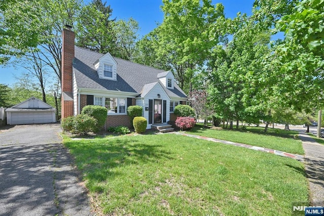 205 Elizabeth, Oradell, NJ 07649 - new england style home with an outbuilding, brick siding, a front yard, a garage, and a chimney