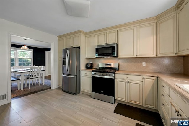 205 Elizabeth, Oradell, NJ 07649 - kitchen with cream cabinetry, appliances with stainless steel finishes, light countertops, and tasteful backsplash