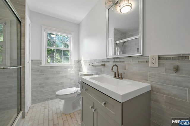 205 Elizabeth, Oradell, NJ 07649 - full bathroom with tile walls, vanity, a stall shower, toilet, and a wainscoted wall