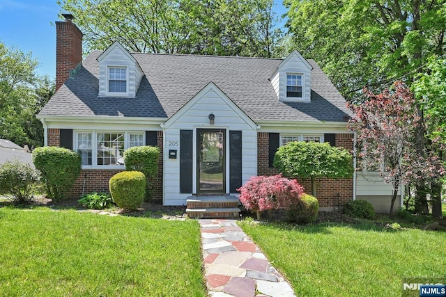 205 Elizabeth, Oradell, NJ 07649 - cape cod-style house with brick siding, a chimney, a front lawn, and a shingled roof