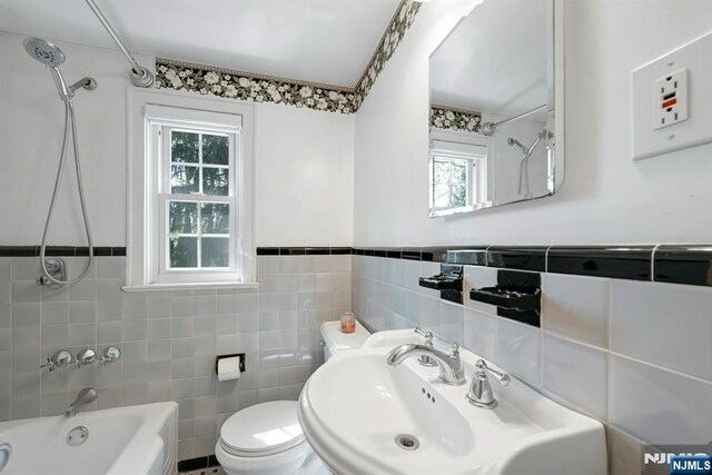 205 Elizabeth, Oradell, NJ 07649 - full bathroom with tile walls, toilet, a sink, wainscoting, and bathtub / shower combination
