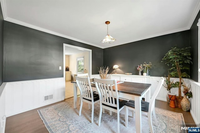 205 Elizabeth, Oradell, NJ 07649 - dining room featuring light wood finished floors, ornamental molding, and a wainscoted wall