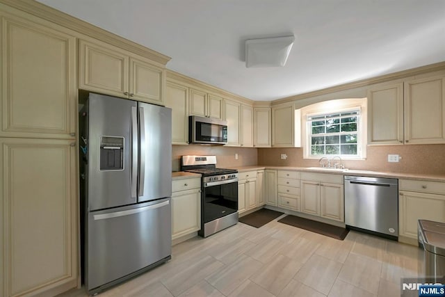 205 Elizabeth, Oradell, NJ 07649 - kitchen with cream cabinets, stainless steel appliances, backsplash, and light countertops