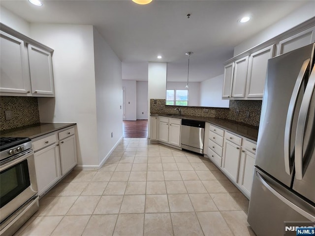 326 The Promenade Unit 326, Edgewater, NJ 07020 - kitchen featuring appliances with stainless steel finishes, dark countertops, decorative backsplash, light tile patterned floors, and recessed lighting