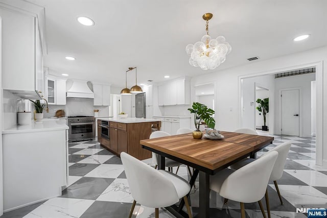 dining space with a chandelier and recessed lighting