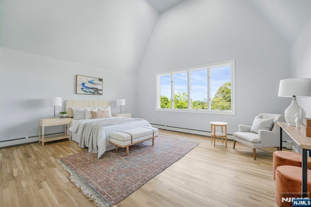 bedroom with high vaulted ceiling, light wood-style floors, and a baseboard radiator