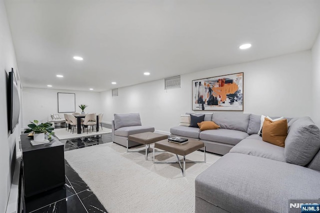 living area with recessed lighting and baseboards