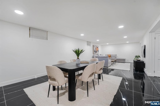 dining room with recessed lighting and baseboards
