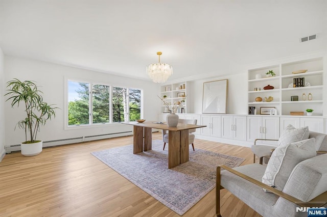 office featuring light wood-style floors, a chandelier, and a baseboard heating unit