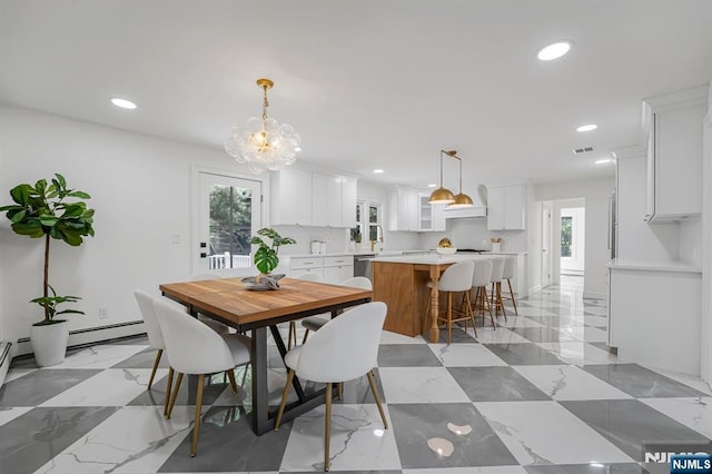 dining space featuring healthy amount of natural light, recessed lighting, a baseboard heating unit, and a chandelier