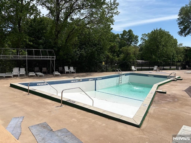 2352 Linwood Ave Unit 7A, Fort Lee, NJ 07024 - community pool featuring fence, a patio area, and view of wooded area