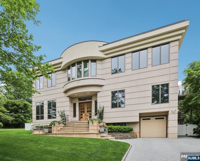435 Cypress Ct, New Milford, NJ 07646 - view of front facade featuring a garage, driveway, french doors, and stucco siding