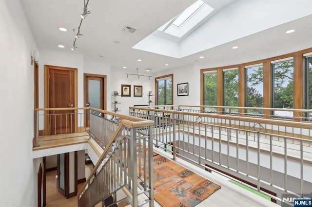435 Cypress Ct, New Milford, NJ 07646 - hallway with recessed lighting, a skylight, wood finished floors, and an upstairs landing
