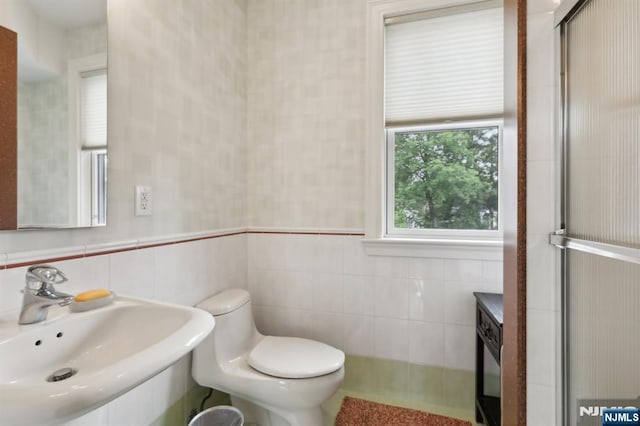 435 Cypress Ct, New Milford, NJ 07646 - bathroom featuring a sink, tile walls, and toilet