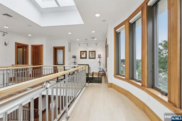 435 Cypress Ct, New Milford, NJ 07646 - corridor featuring a skylight, light wood-type flooring, recessed lighting, an upstairs landing, and baseboards