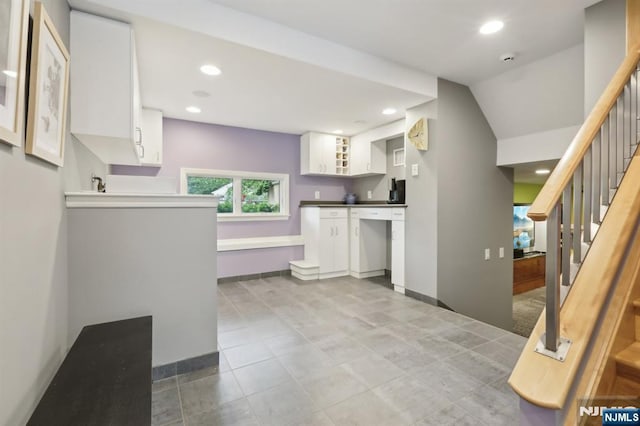435 Cypress Ct, New Milford, NJ 07646 - kitchen with white cabinets, recessed lighting, light tile patterned flooring, baseboards, and dark countertops