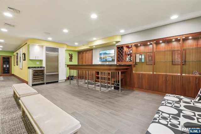 435 Cypress Ct, New Milford, NJ 07646 - indoor dry bar featuring wine cooler, built in fridge, light wood-style flooring, and recessed lighting
