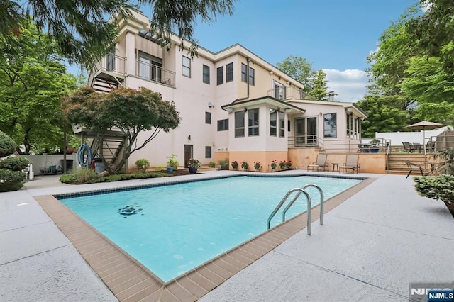 435 Cypress Ct, New Milford, NJ 07646 - view of swimming pool with a patio, stairway, and a sunroom