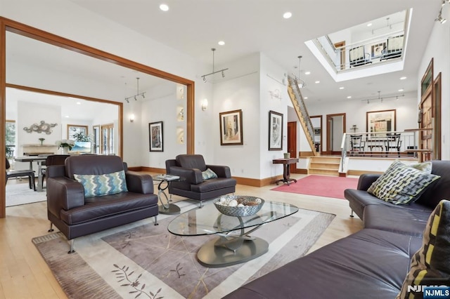 435 Cypress Ct, New Milford, NJ 07646 - living area featuring recessed lighting, wood finished floors, a skylight, stairway, and baseboards