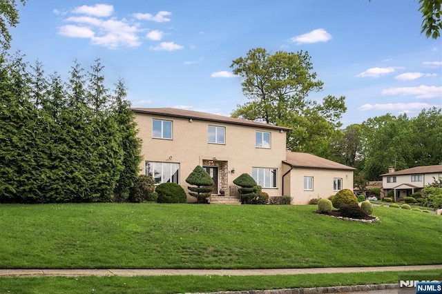 rear view of property with a lawn