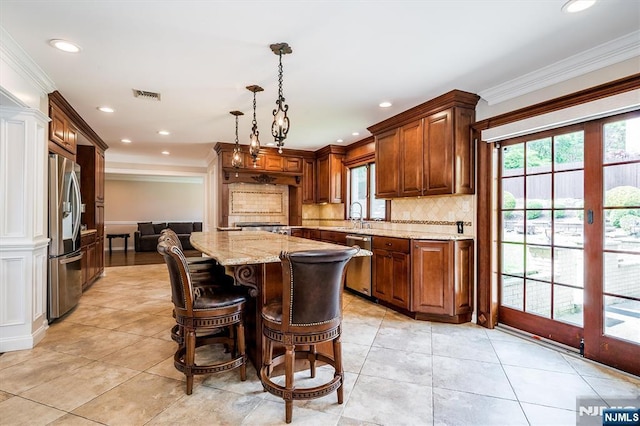 kitchen featuring stainless steel appliances, light stone counters, backsplash, light tile patterned floors, and crown molding