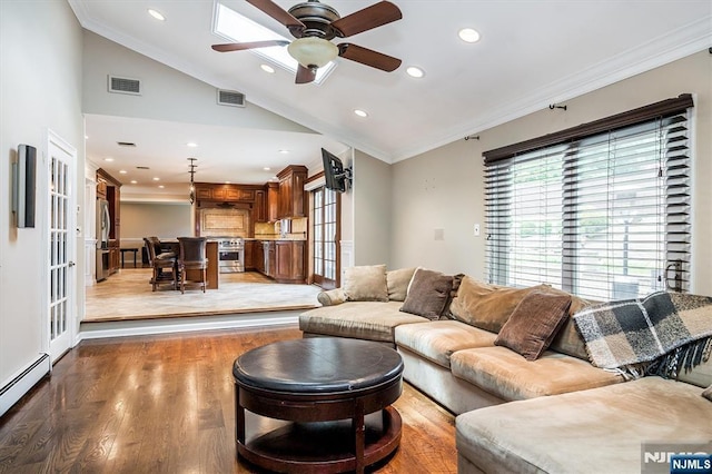 living room with vaulted ceiling, baseboard heating, crown molding, light wood-style flooring, and a ceiling fan