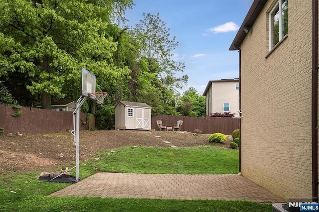 view of yard featuring a storage shed, an outbuilding, and a patio area
