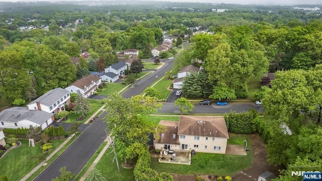aerial perspective of suburban area featuring a heavily wooded area