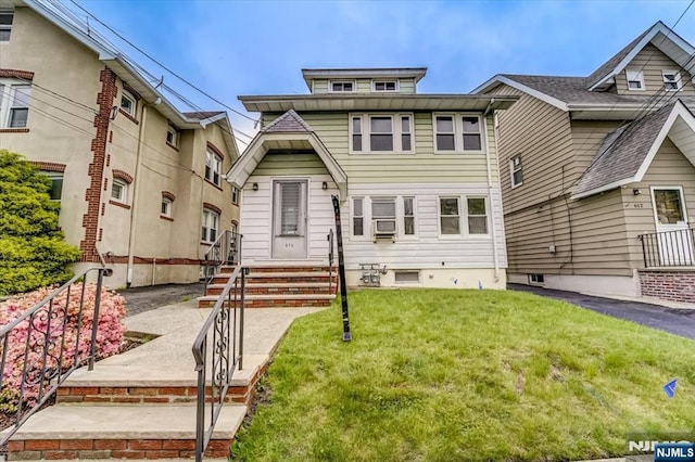 american foursquare style home with a front lawn
