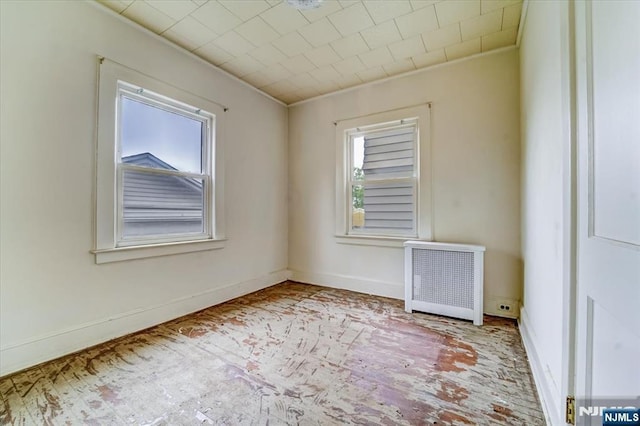 spare room featuring radiator heating unit and baseboards