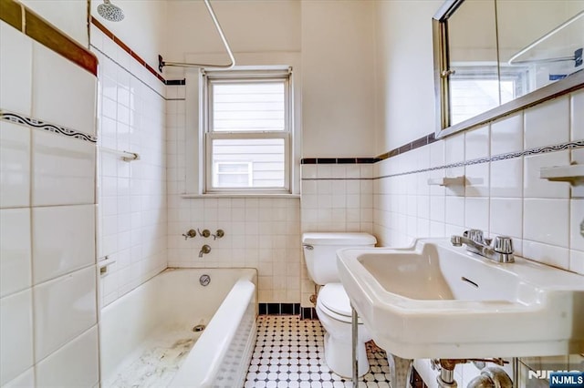 full bathroom featuring a bath, toilet, tile walls, a shower, and a sink