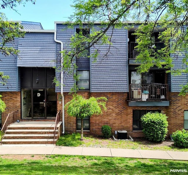 700 Schuyler Unit D16, Kearny, NJ 07032 - view of front of house featuring brick siding and central AC