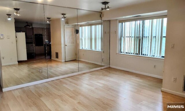 700 Schuyler Unit D16, Kearny, NJ 07032 - unfurnished bedroom featuring wood finished floors, baseboards, and refrigerator