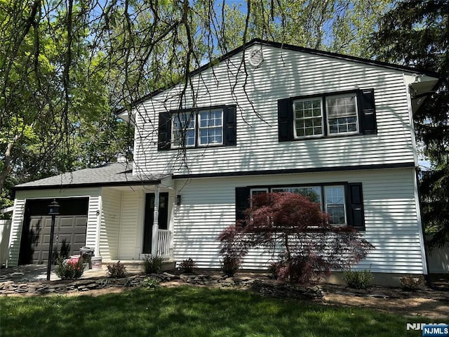 view of front of property with a garage and a front yard