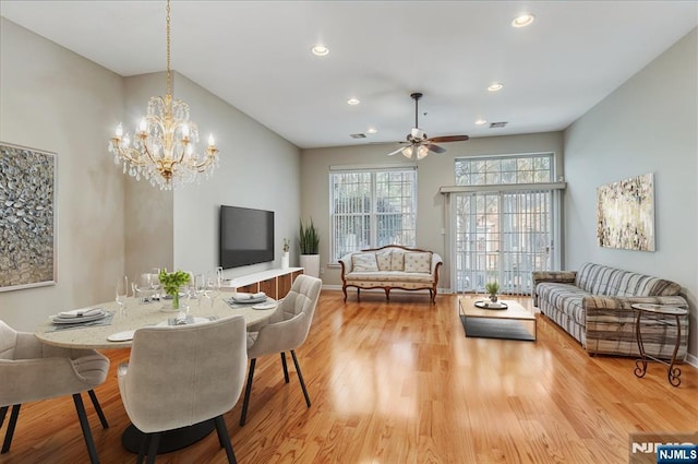 dining room with light wood-style flooring, recessed lighting, ceiling fan, a chandelier, and baseboards