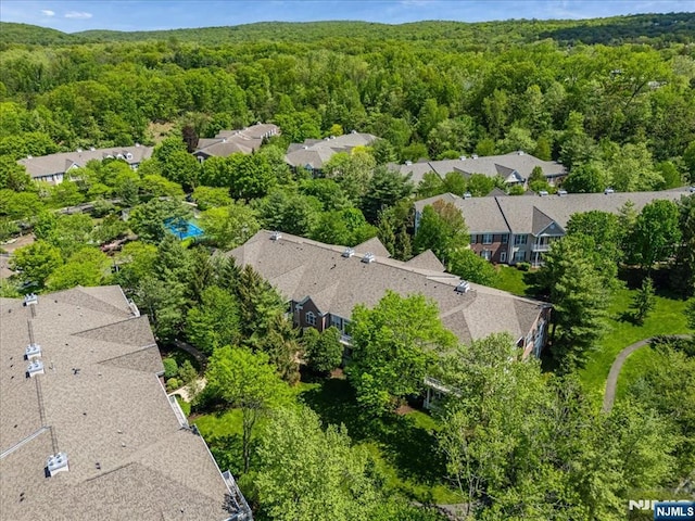 aerial view of residential area with a heavily wooded area
